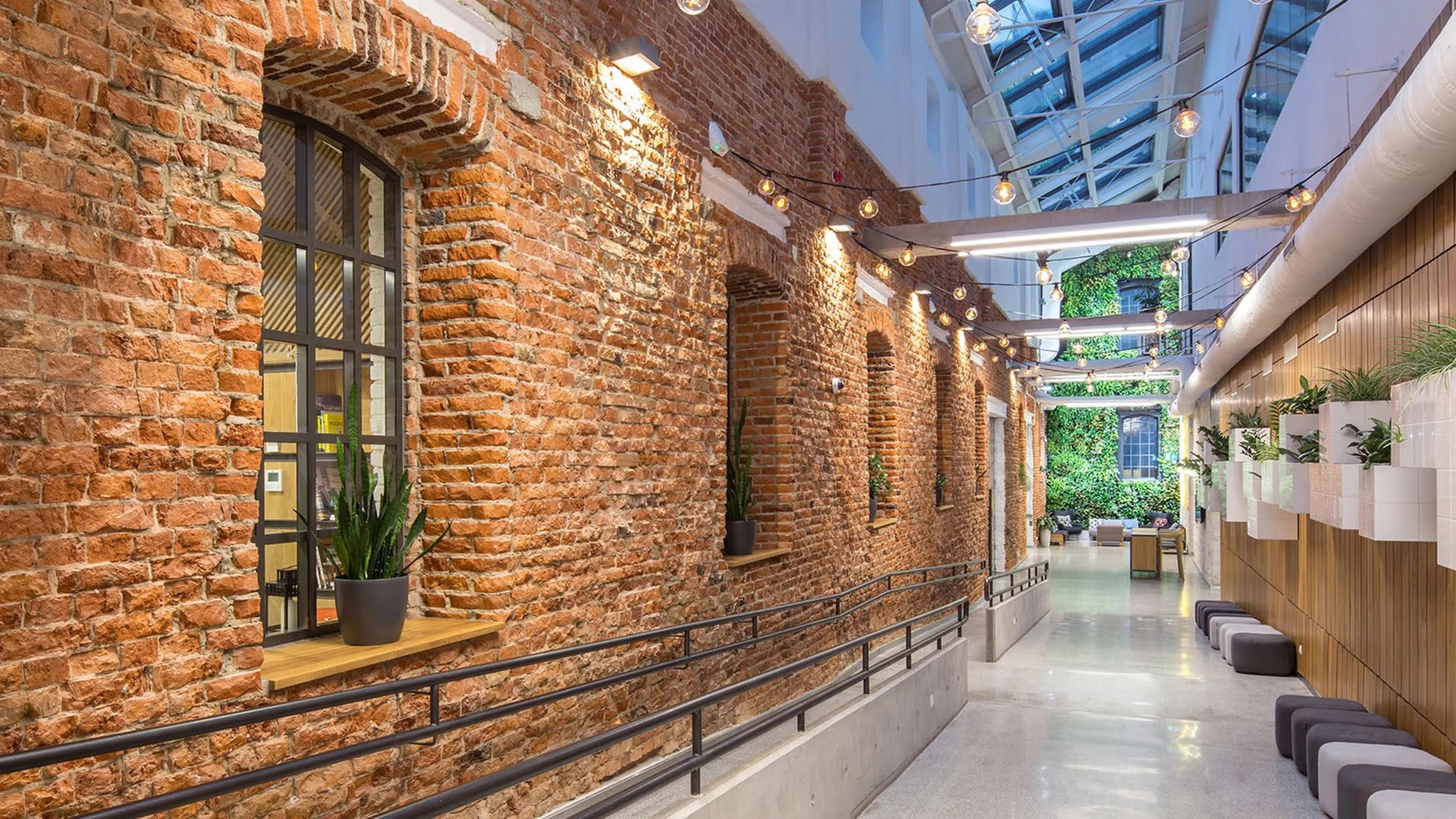 The inside of a long hallway inside a modern business building.