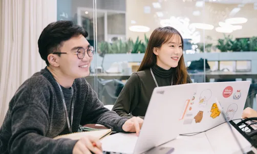 A man and woman looking at something.