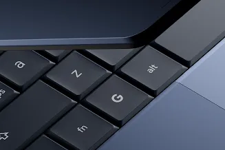 Close-up of the corner of a Google key on the laptop’s keyboard as it hinges open.