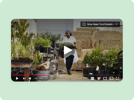 A mockup of a YouTube video player overlay set against a pale green background. The video content shows a woman carrying a tray of small plants through an urban farm or garden center filled with potted plants, hay bales, and chickens walking on the ground. A card in the top right corner reads "Grow Hope: Fund Sustain...". The video playback bar at the bottom is paused at 5:07.