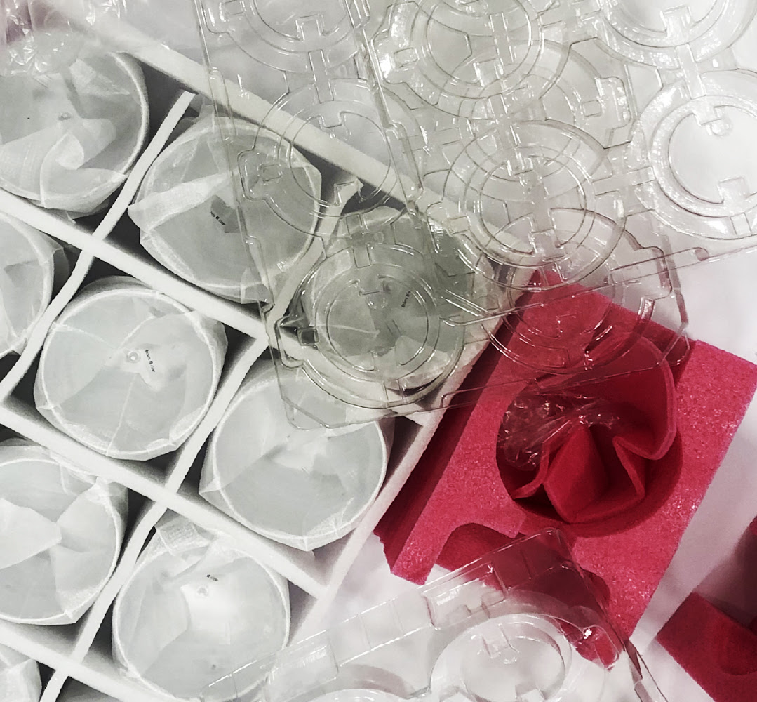 An aerial close up view of different types of packaging including protective foam and divider trays