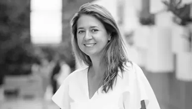 Founder Kasia Dorsey stands along a railing outdoors.