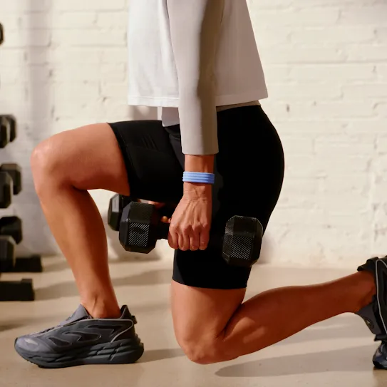 A person lunges while holding weights