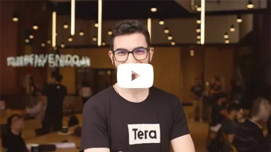 Grupo de pessoas posando para foto junto a uma placa com o logo da Tera.