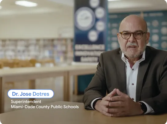 A video frame featuring Dr. Jose Dotres, Superintendent of Miami-Dade County Public Schools, speaking in a library setting.
