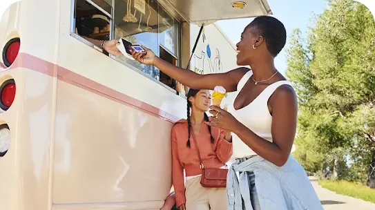 Woman paying for ice-cream using NFC