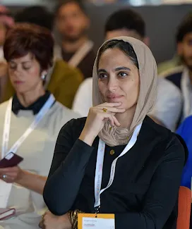 The lady in the scarf is giving her rapt attention to the event.