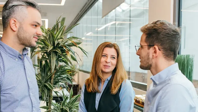 Three people are discussing