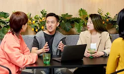 A man is explaining business strategy to his colleagues.
