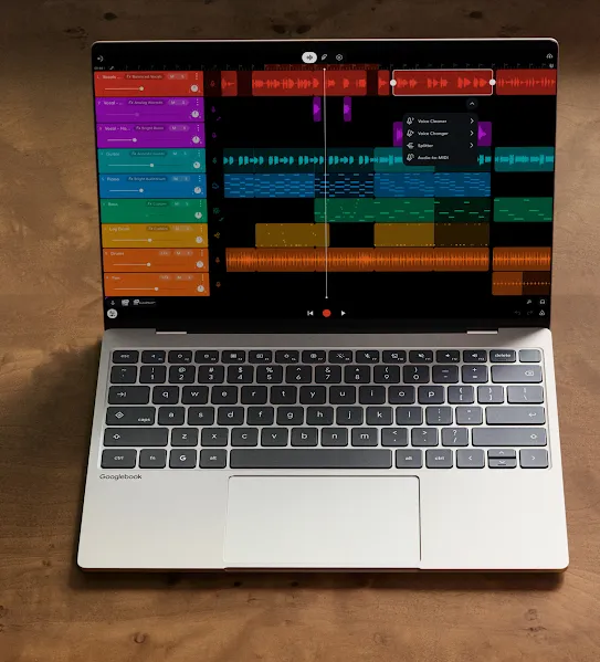 A Googlebook laptop and Android phone side by side on a wooden desk, both displaying a music production app.