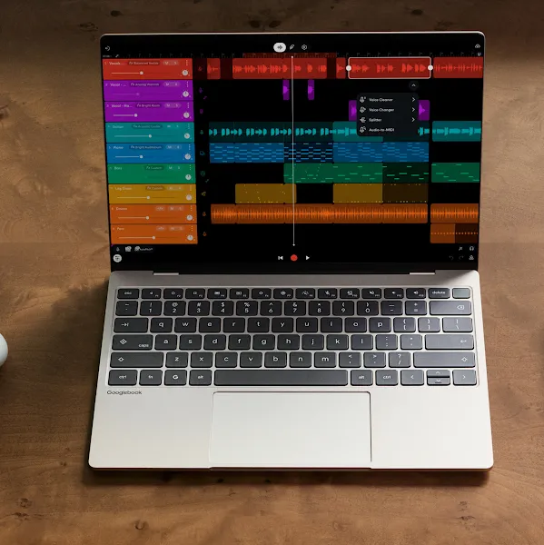 A Googlebook laptop and Android phone side by side on a wooden desk, both displaying a music production app.
