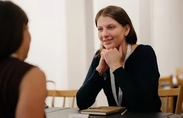 Two women engaged in a pleasant conversation.