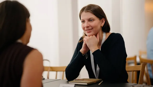 Two women engaged in a pleasant conversation.