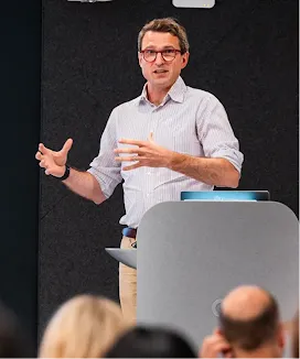 A person in glasses is leading a successful session at the event.