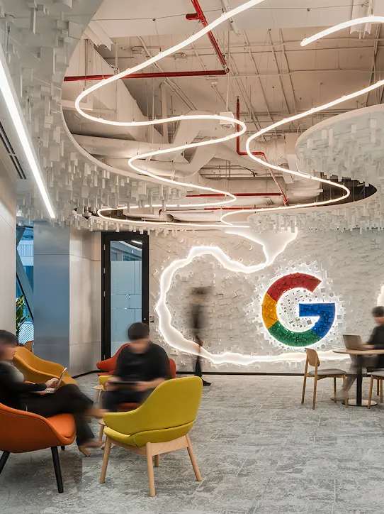 An office kitchen with multiple people working.