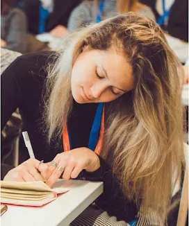 A lady holding pen and writing