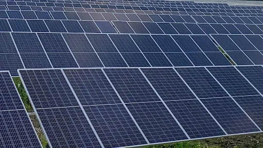A photograph of an array of solar panels on a farm