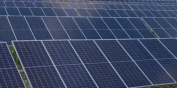 A photograph of an array of solar panels on a farm
