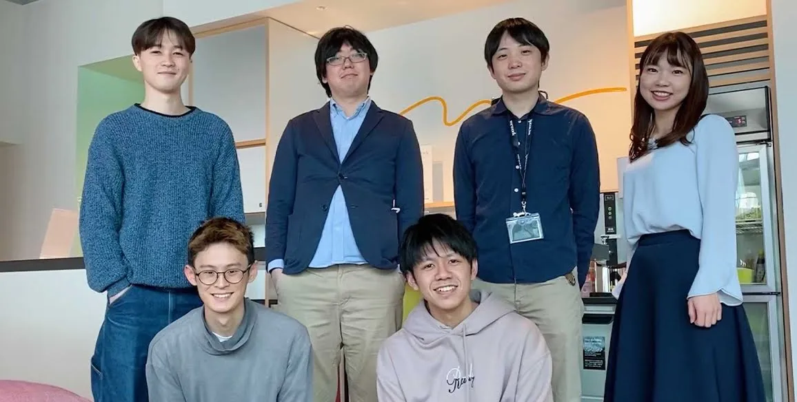 The Latona team pose together indoors for the camera.