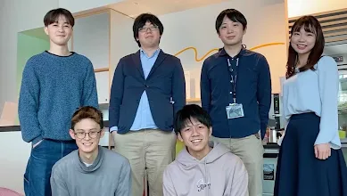 The Latona team pose together indoors for the camera.