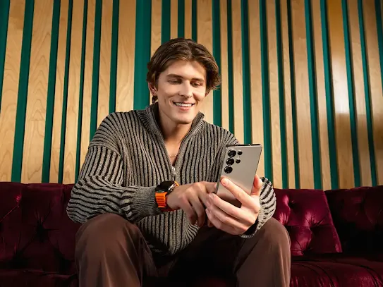 Man sitting holding Android phone