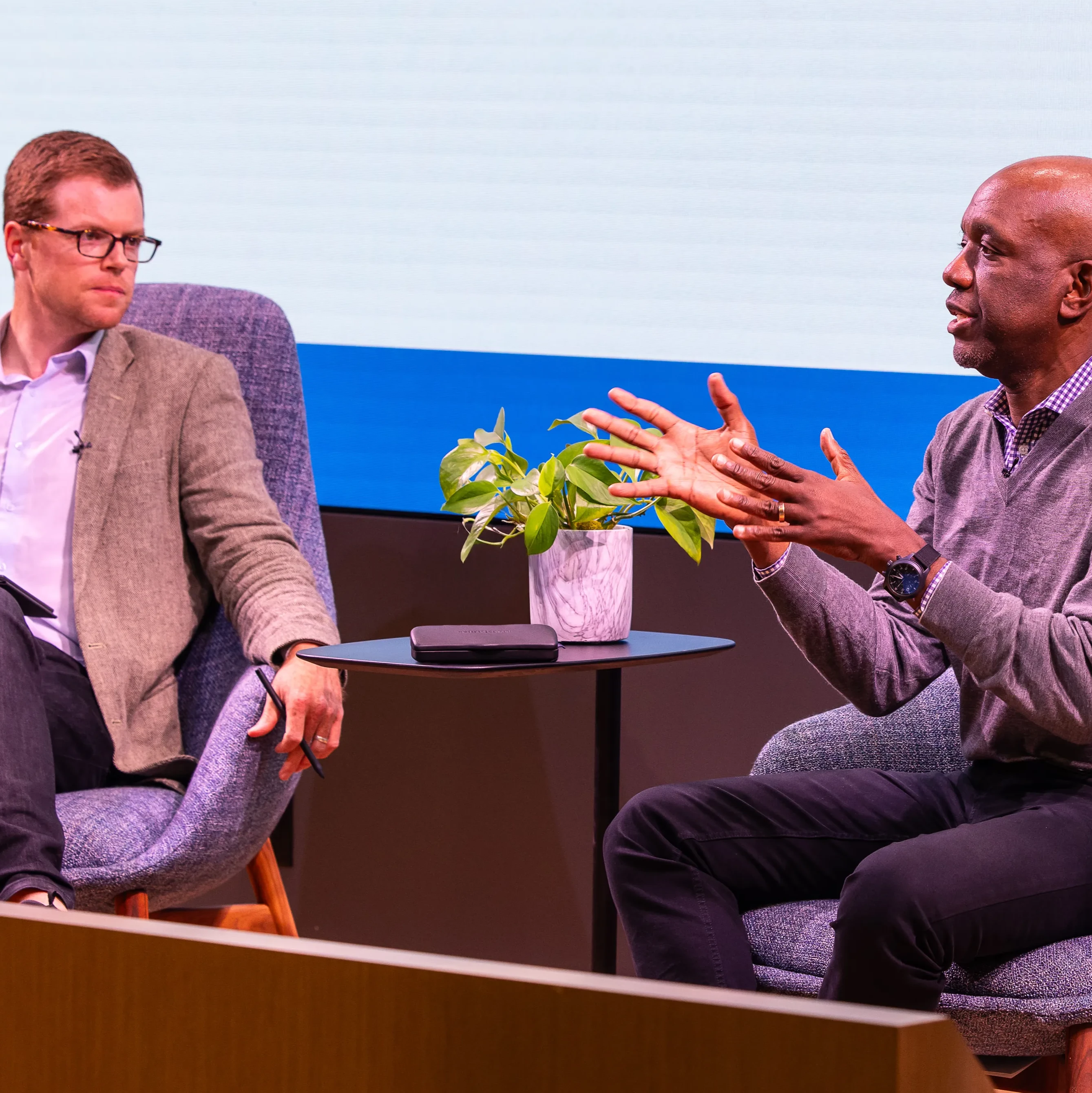 A photo of a fireside conversation between James Manyika and Ben Armstrong at a Google event