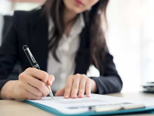 Businesswoman signing contract.