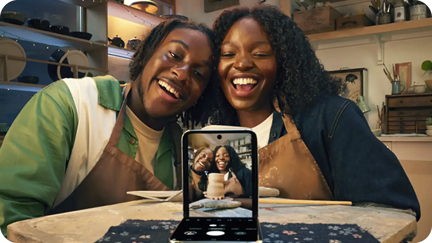 Two people taking a picture with Galaxy Z Flip 5 phone