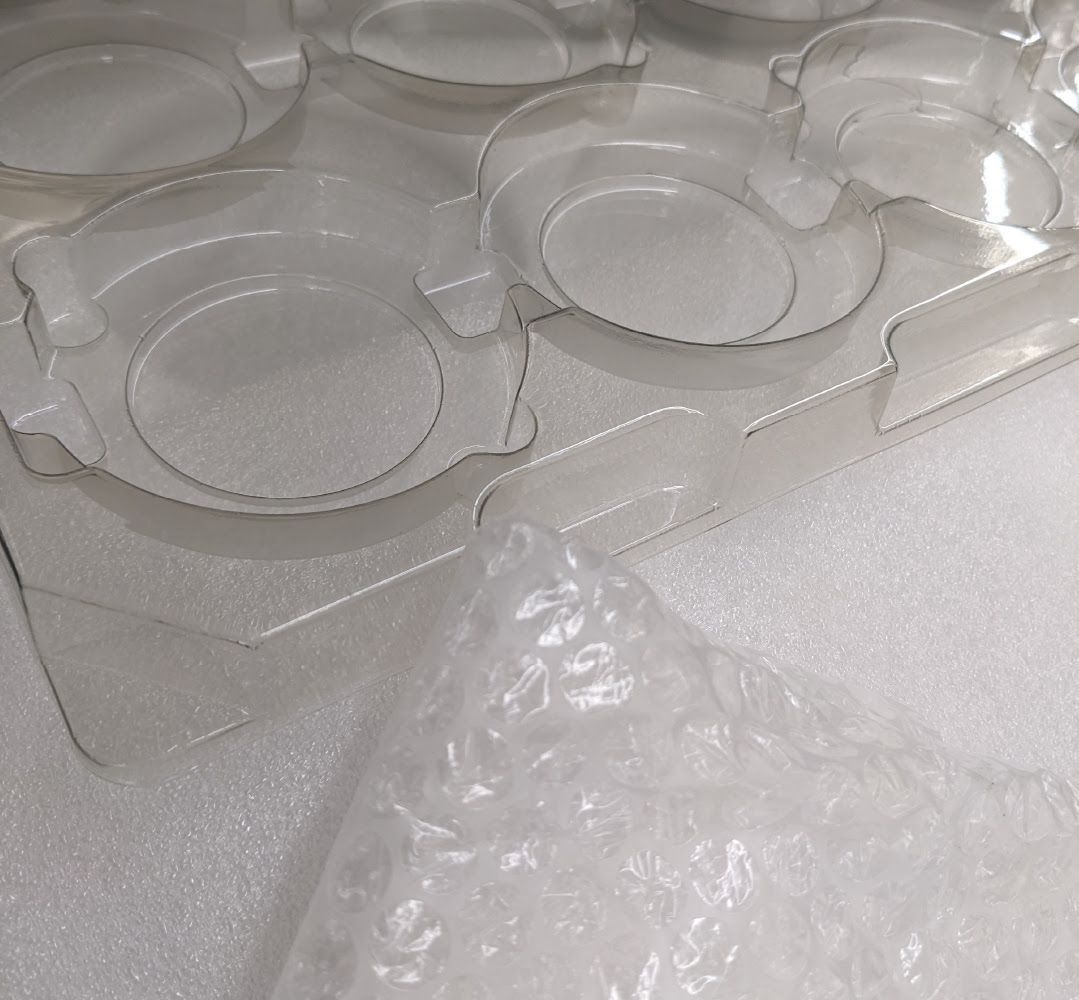 An alternate view of two different types of packaging including divider trays