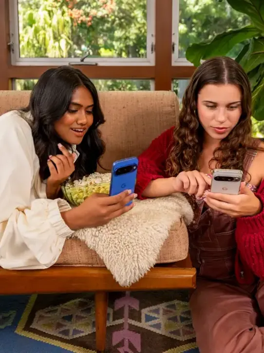 Women holding and using their Android devices.