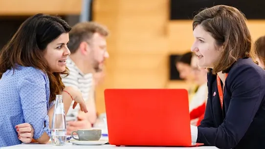Two women are discussing