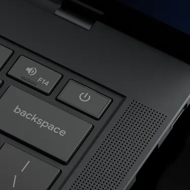 Close-up of the Googlebook keyboard corner showing the power button, volume keys, backspace key, and speakers.