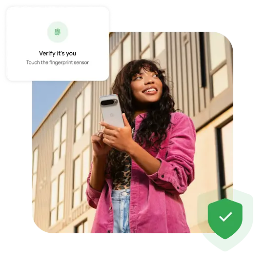 A person wearing jeans with a leopard print shirt underneath a pink corduroy jacket holds a Pixel phone while looking to the side. A building is in the background