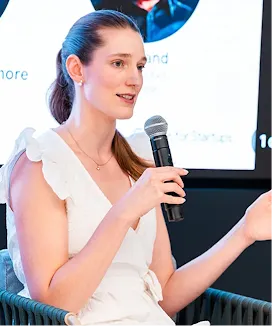 The female host, with a mic in hand, is delivering an excellent event.