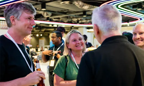 A group of people engaged in a discussion at an event.