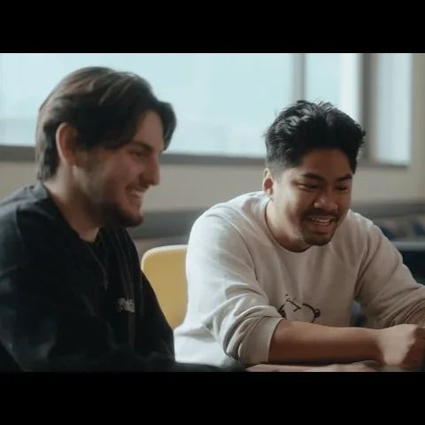 Two students are working together in a college setting