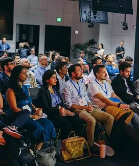 Un grupo de personas prestando atención a una presentación