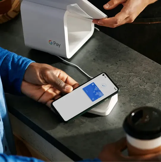 someone using Google Pay to pay for their burger and fries at a restaurant