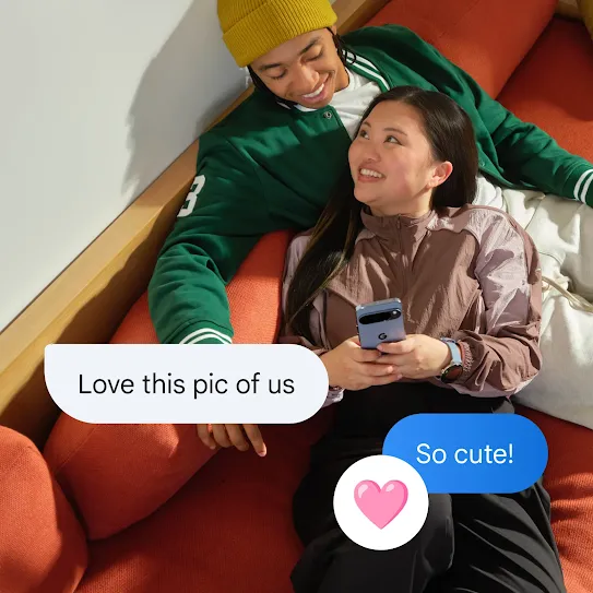 A couple is relaxing on a couch, smiling at each other. One of them lays their head in the other’s lap and holds a phone. Overlaid on the image are chat bubbles that read, "Love this pic of us," "So cute!," and a heart emoji reaction.