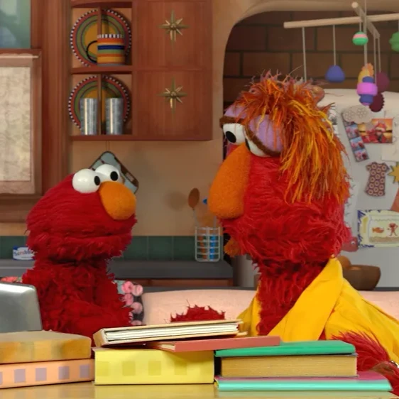 A photograph of two muppets in a classroom setting
