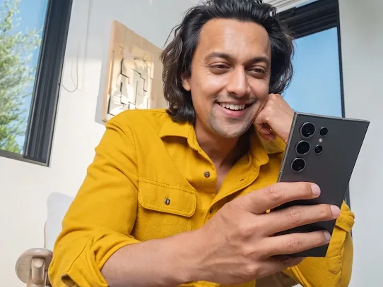 Image of a man using his Android-powered device