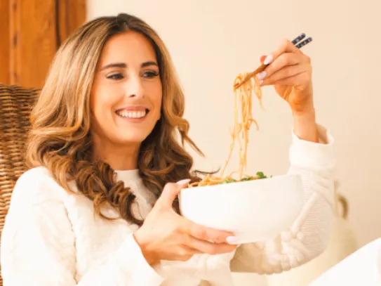 Jennifer Pallian relaxing with a bowl of noodles