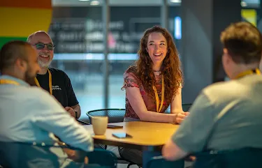 People seated at a table, enjoying a meaningful discussion.