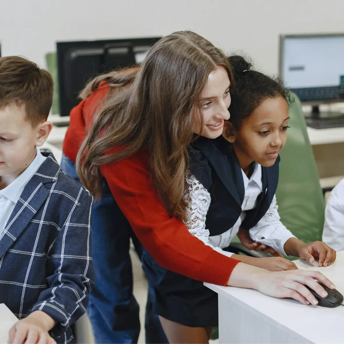 Teacher using a computer with students