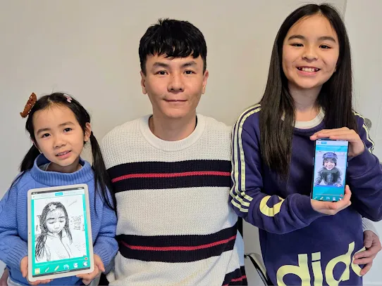 “Dad made that.” Martin Dong and his daughters hold up Pencil Sketch creations of their own.