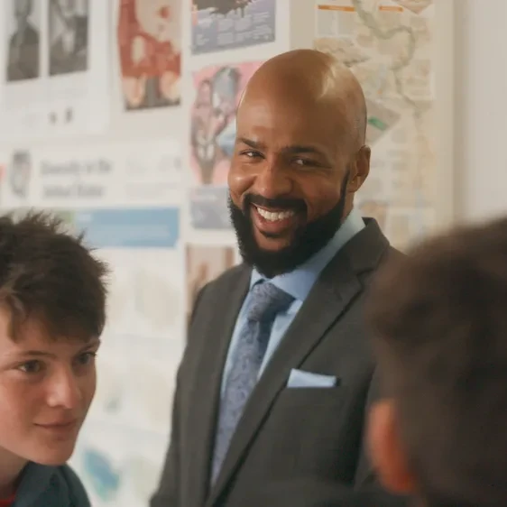 Leon Smith, the 2026 National Teacher of the Year, standing in front of a classroom surrounded by students