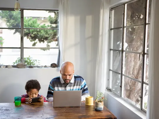 Father and son on devices.