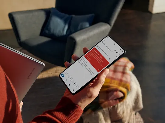 Woman receiving message to reset password on her device