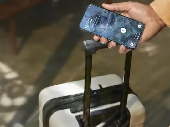 Travelling man holding his Android phone