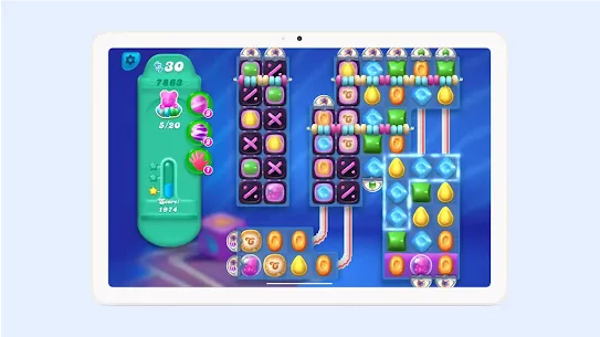 A tablet displaying Candy Crush Soda Saga with straws, candies, and the score on screen.